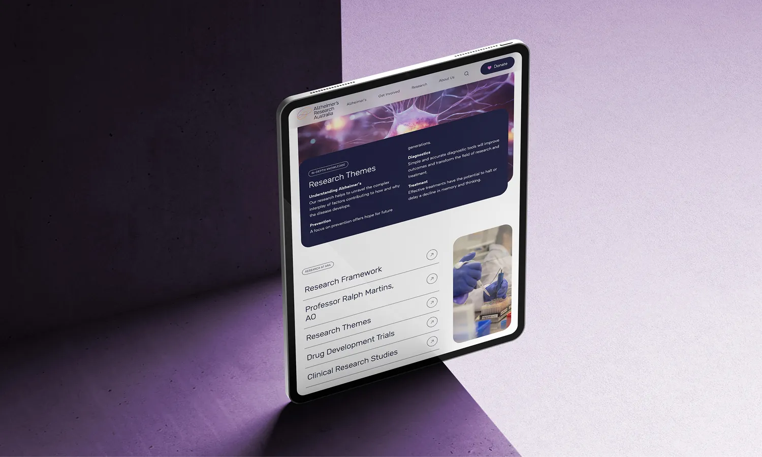 iPad mockup against a purple background showing the Alzheimer's Australia website design