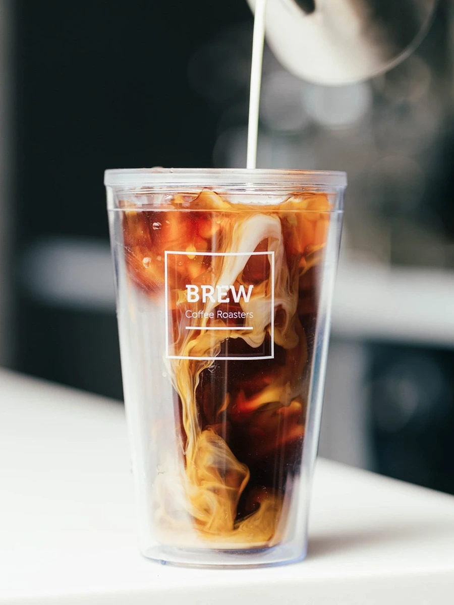 A glass of iced coffee or cold brew on a clean white surface — minimal Brew Coffee product photography