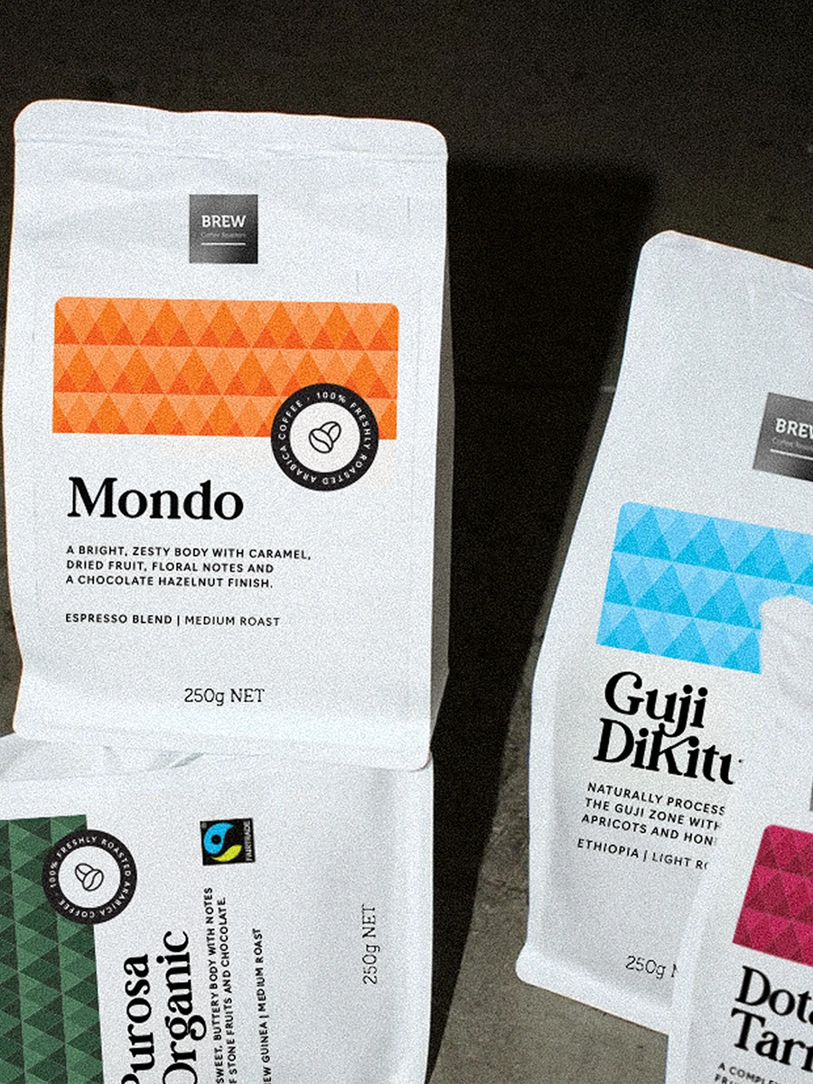 Two Brew Coffee branded bags — Mondo and a second blend — displayed as product photography with Fair Trade certification visible