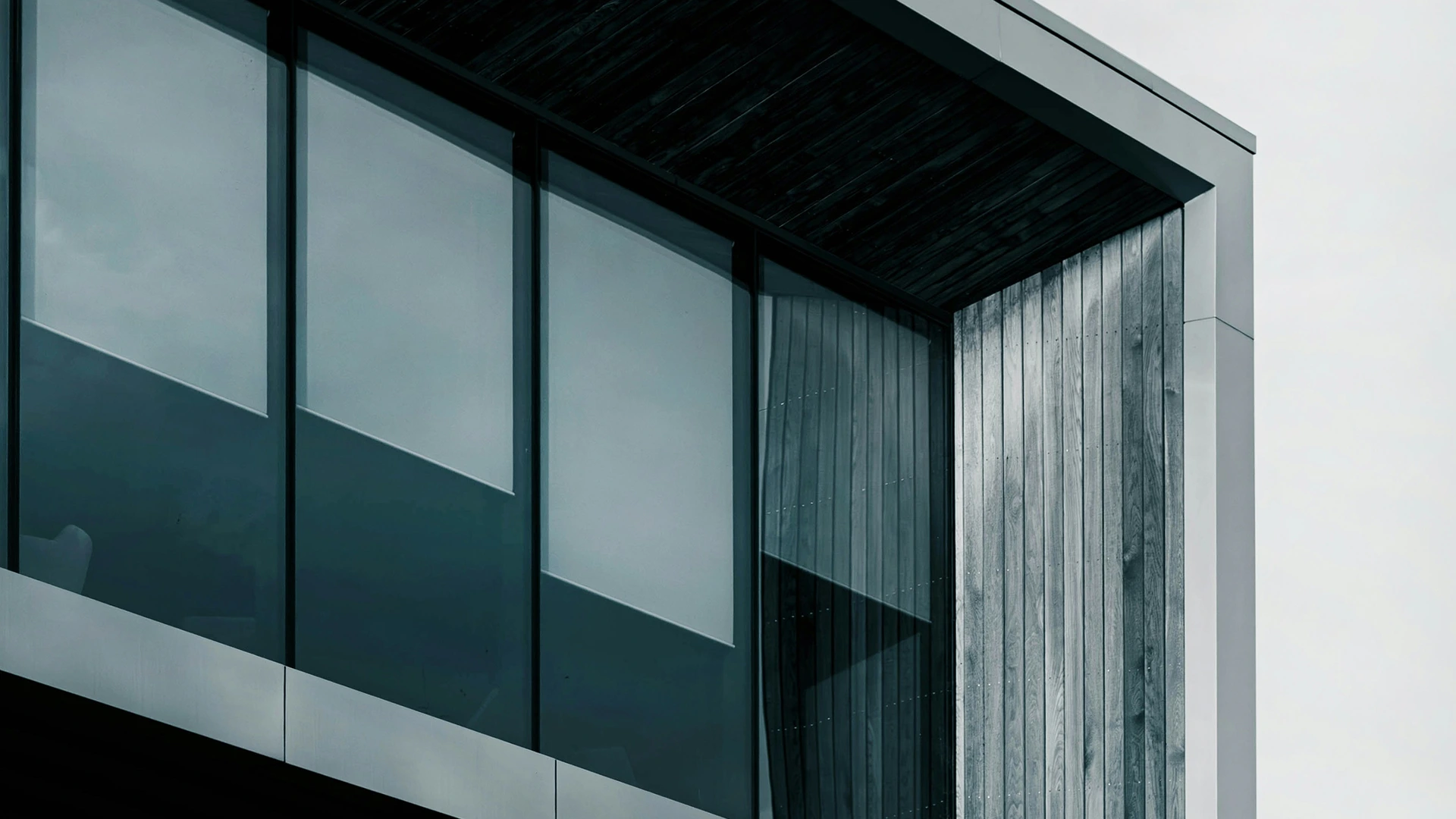 Architectural detail of a geometric concrete or steel building facade with strong diagonal lines