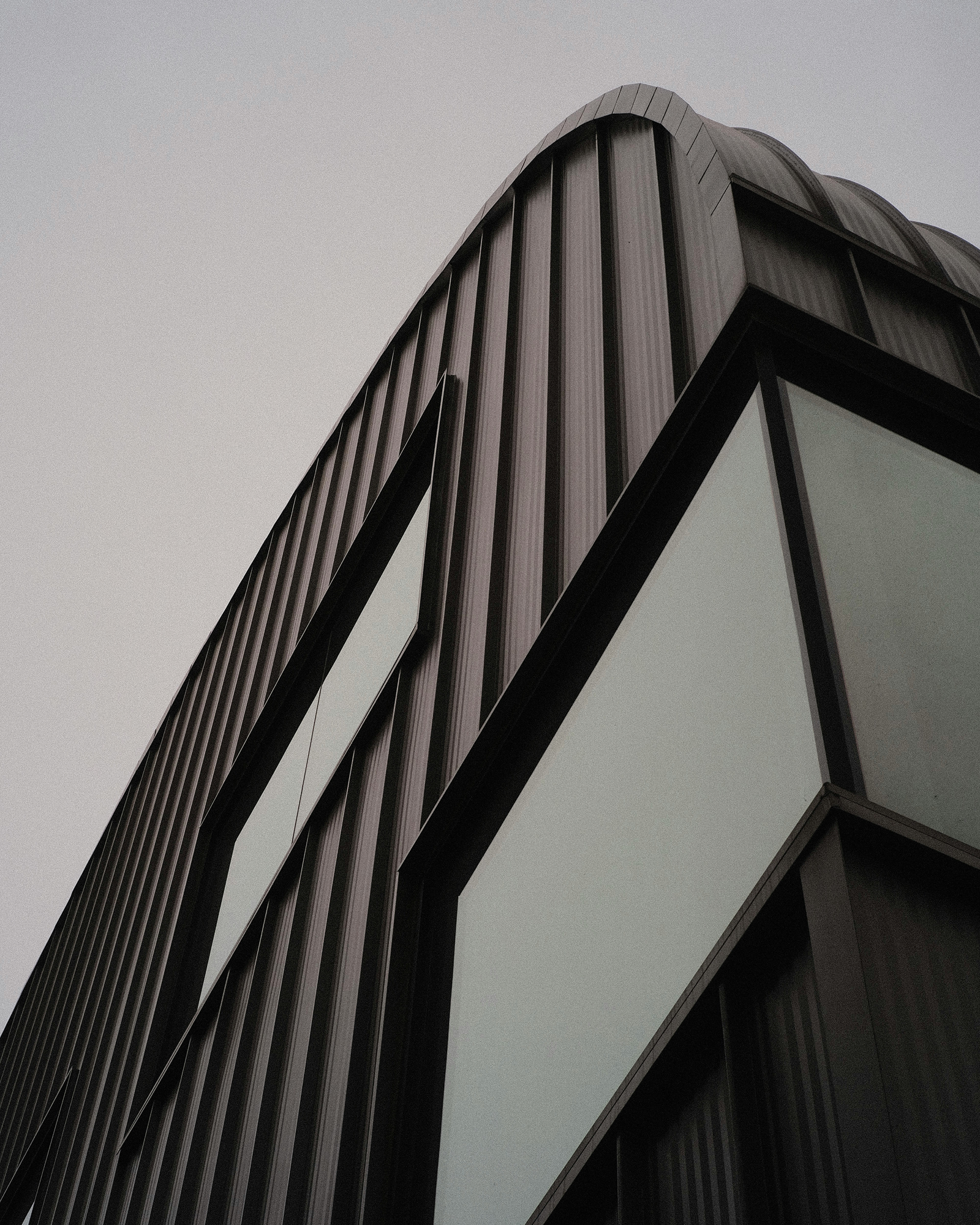 Angular dark building structure photographed from below at a dramatic angle