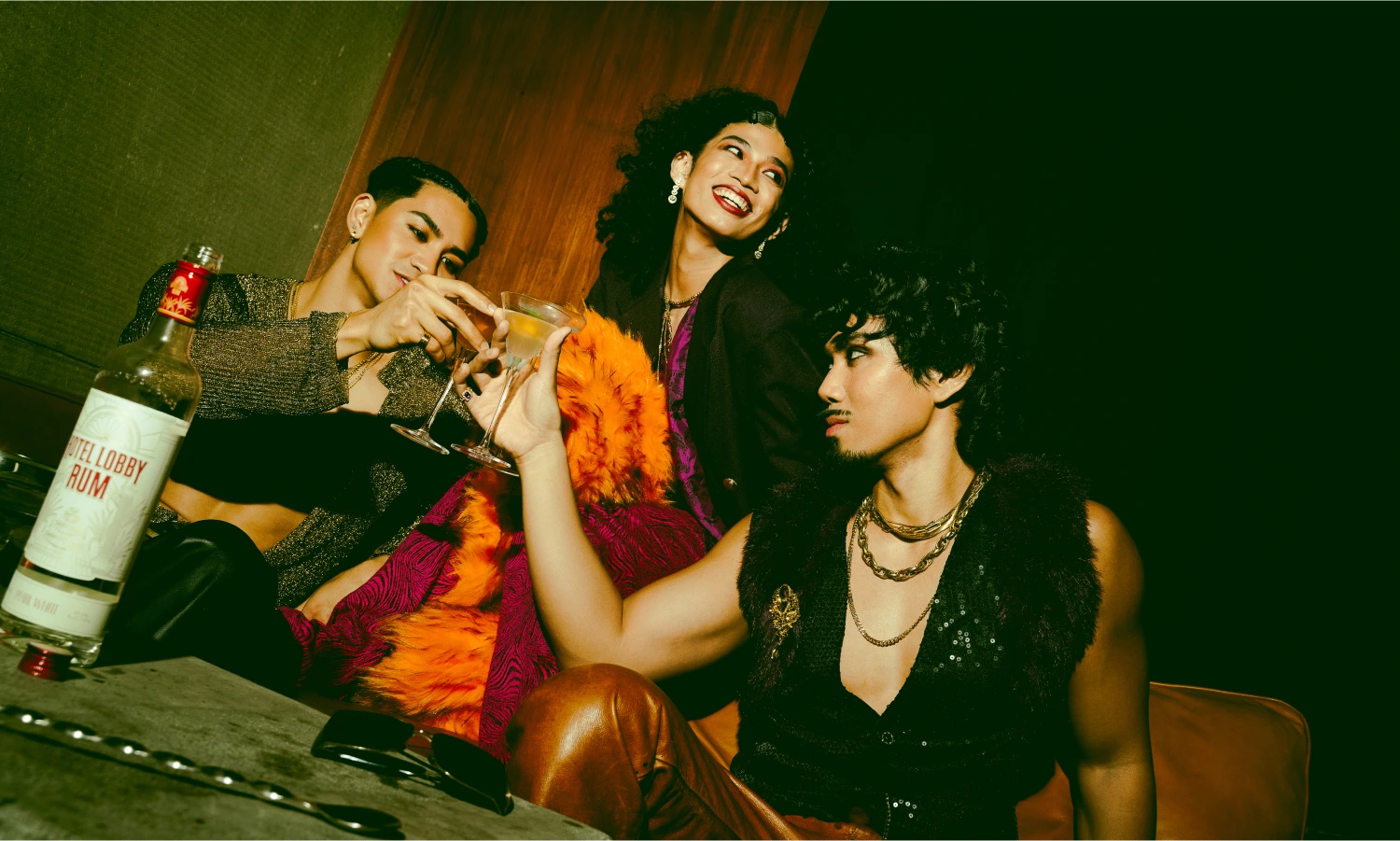 Hotel Lobby Rum group lifestyle scene — glamorous people gathered in a theatrical bar setting