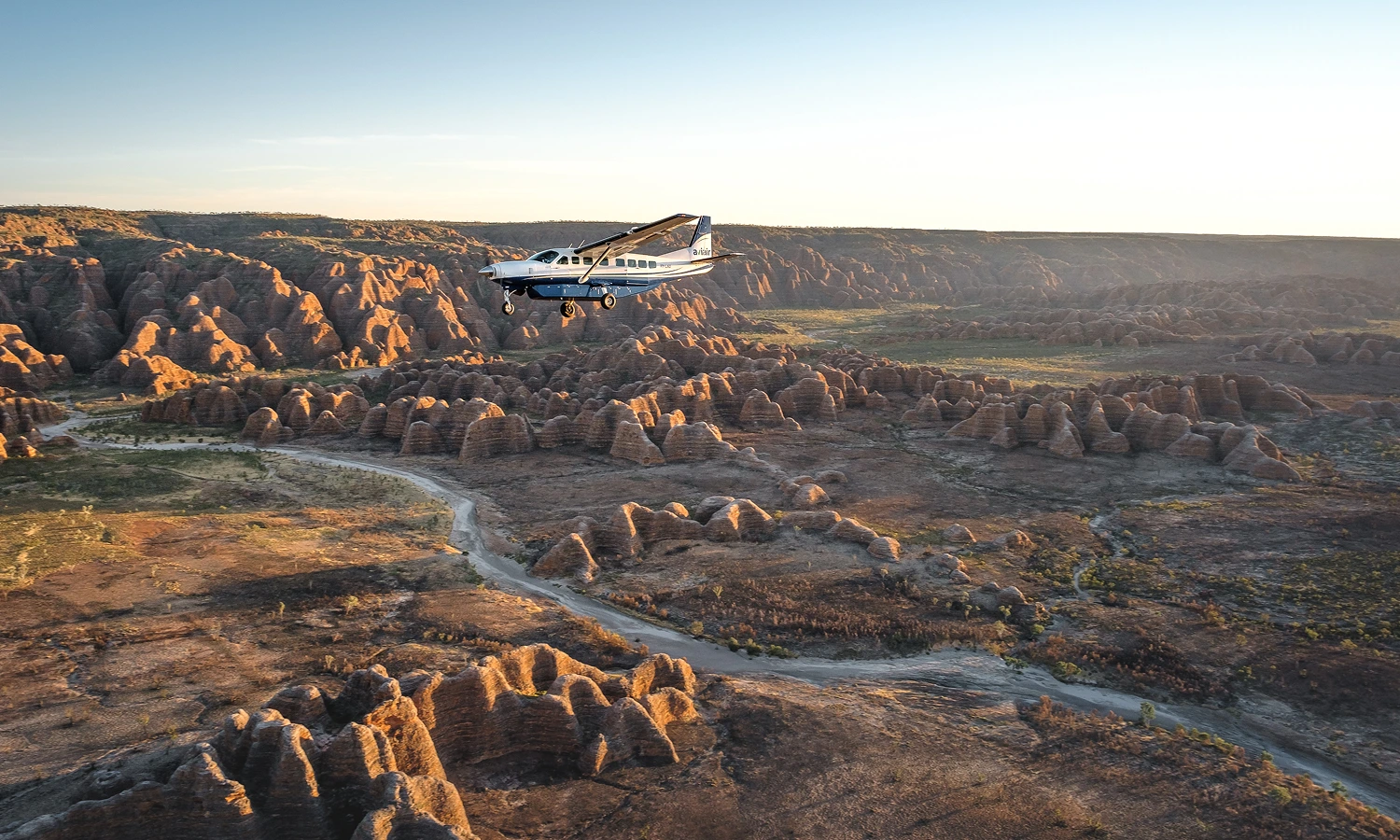 Aerial view of dramatic Australian Kimberley landscape with rugged red rock formations stretching to the horizon — Nexus Airlines spinner graphic