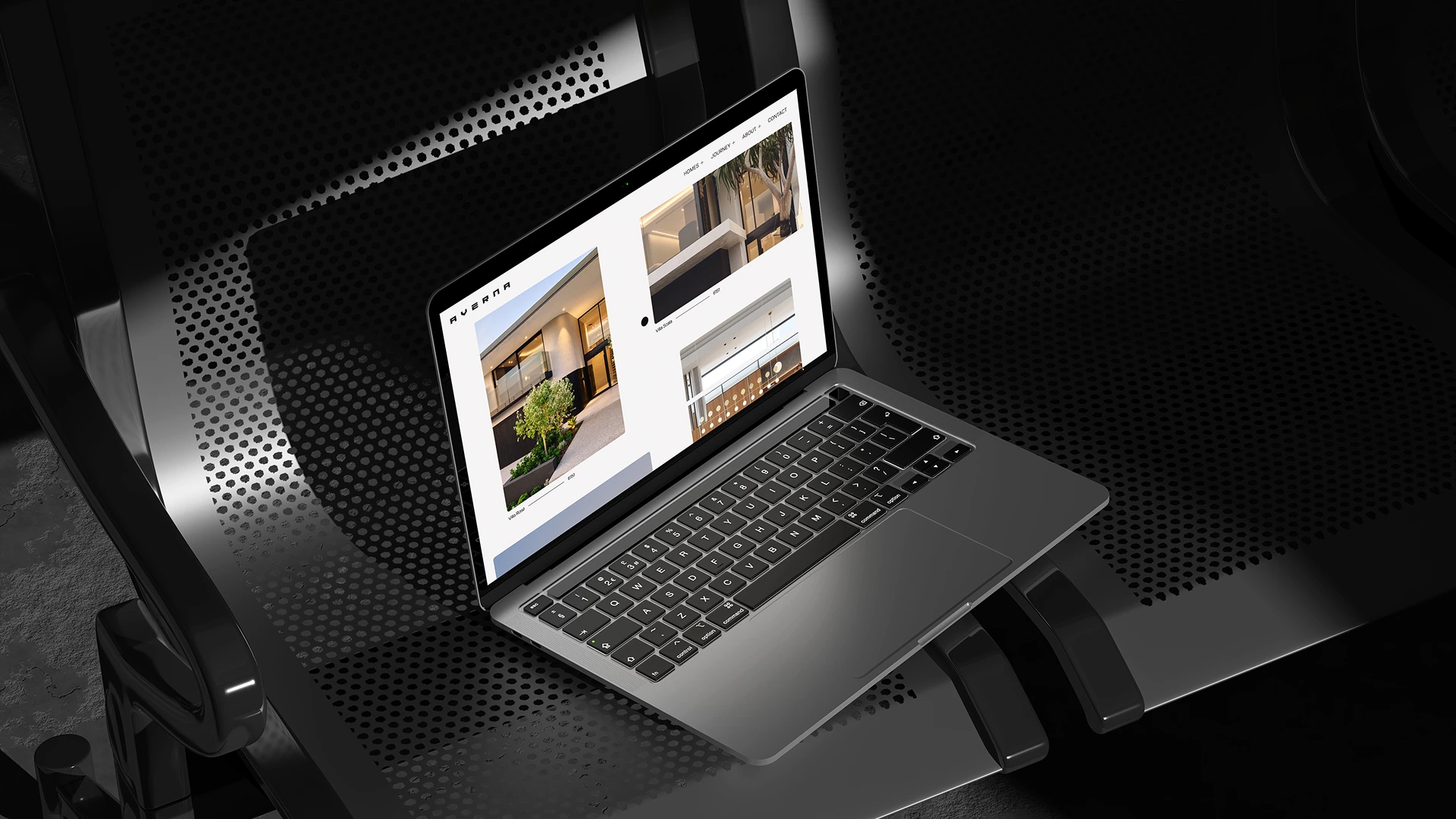 MacBook laptop viewed from above on a dark textured surface showing a website design