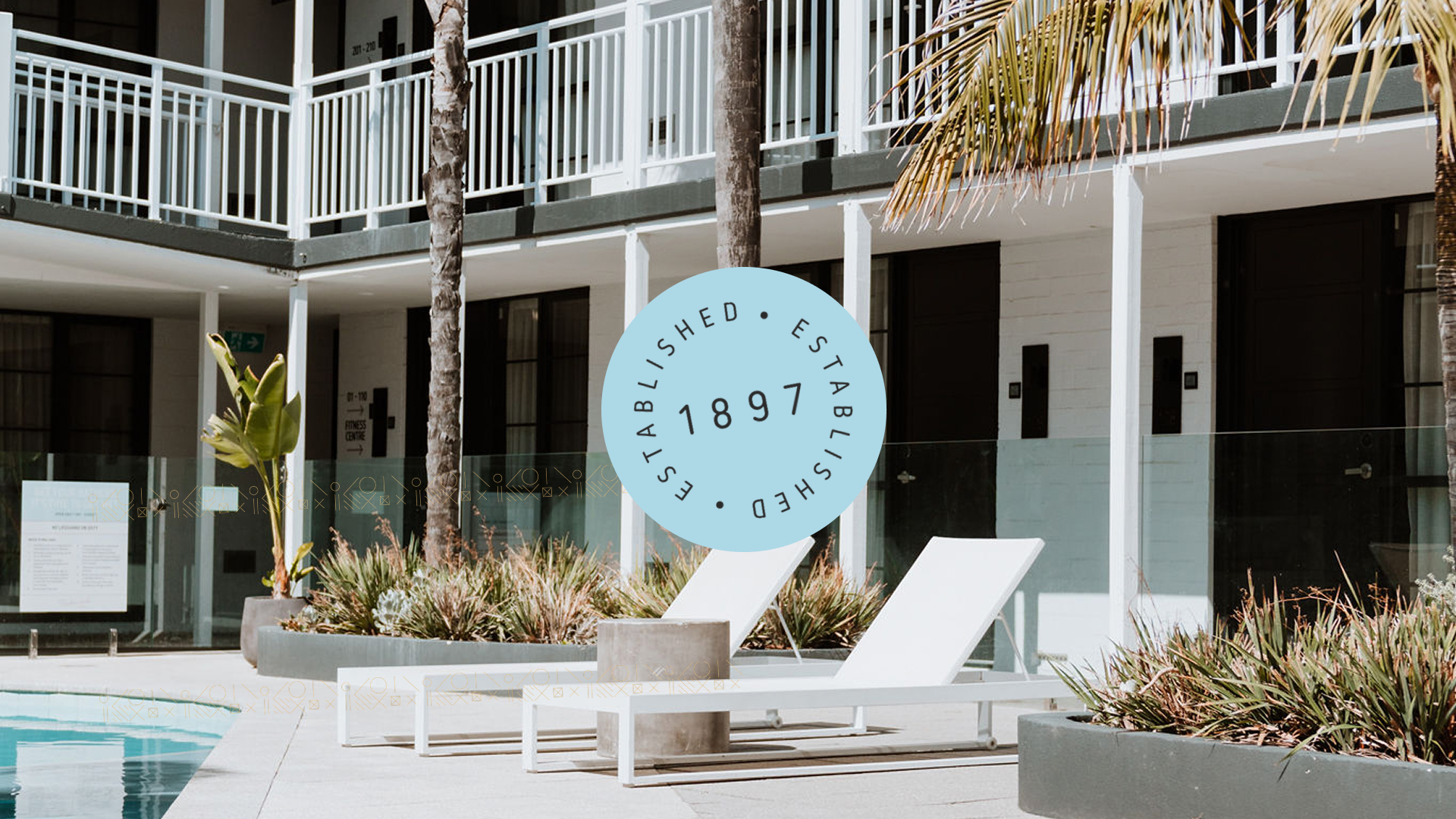Tradewinds Hotel exterior with colonial-style architecture pool and outdoor terrace seating, resort lifestyle photography