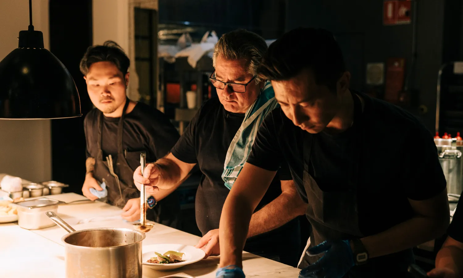 Two chefs working together in a professional restaurant kitchen