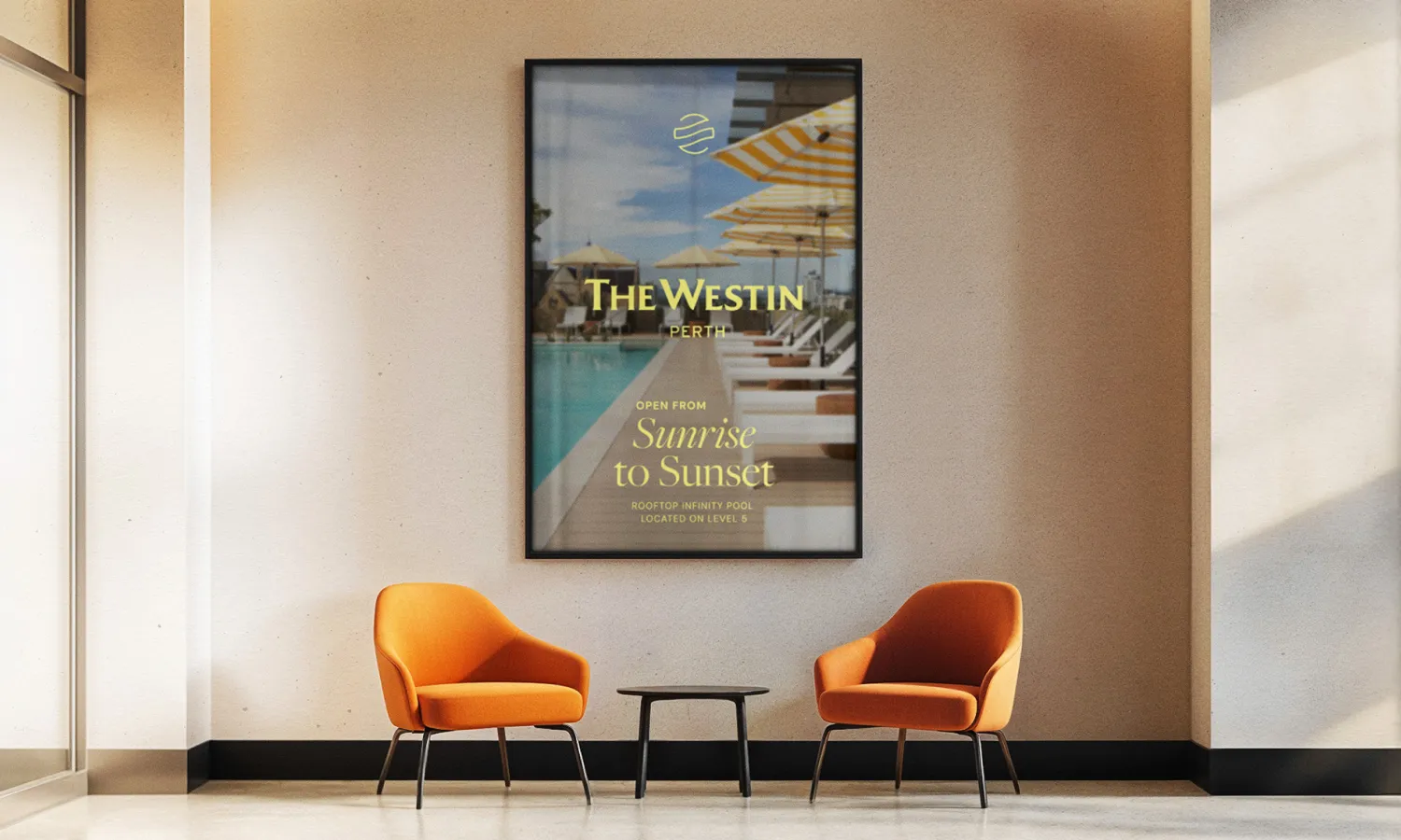The Westin hotel interior with a 'Naturally and Nurtured' framed poster and orange armchairs