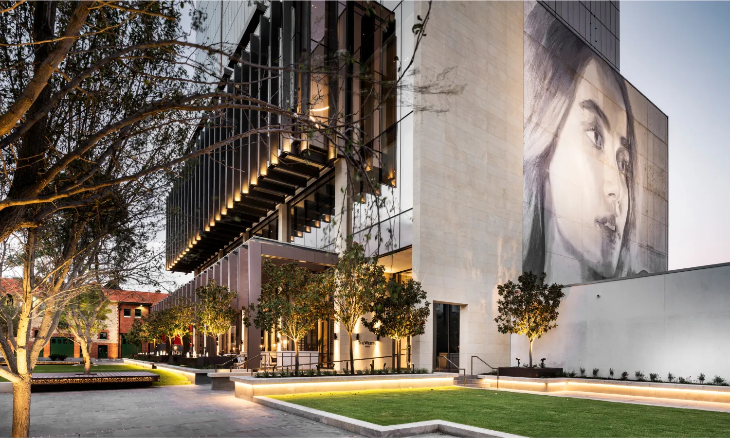Large-scale outdoor building display with an oversized portrait photograph on a building facade