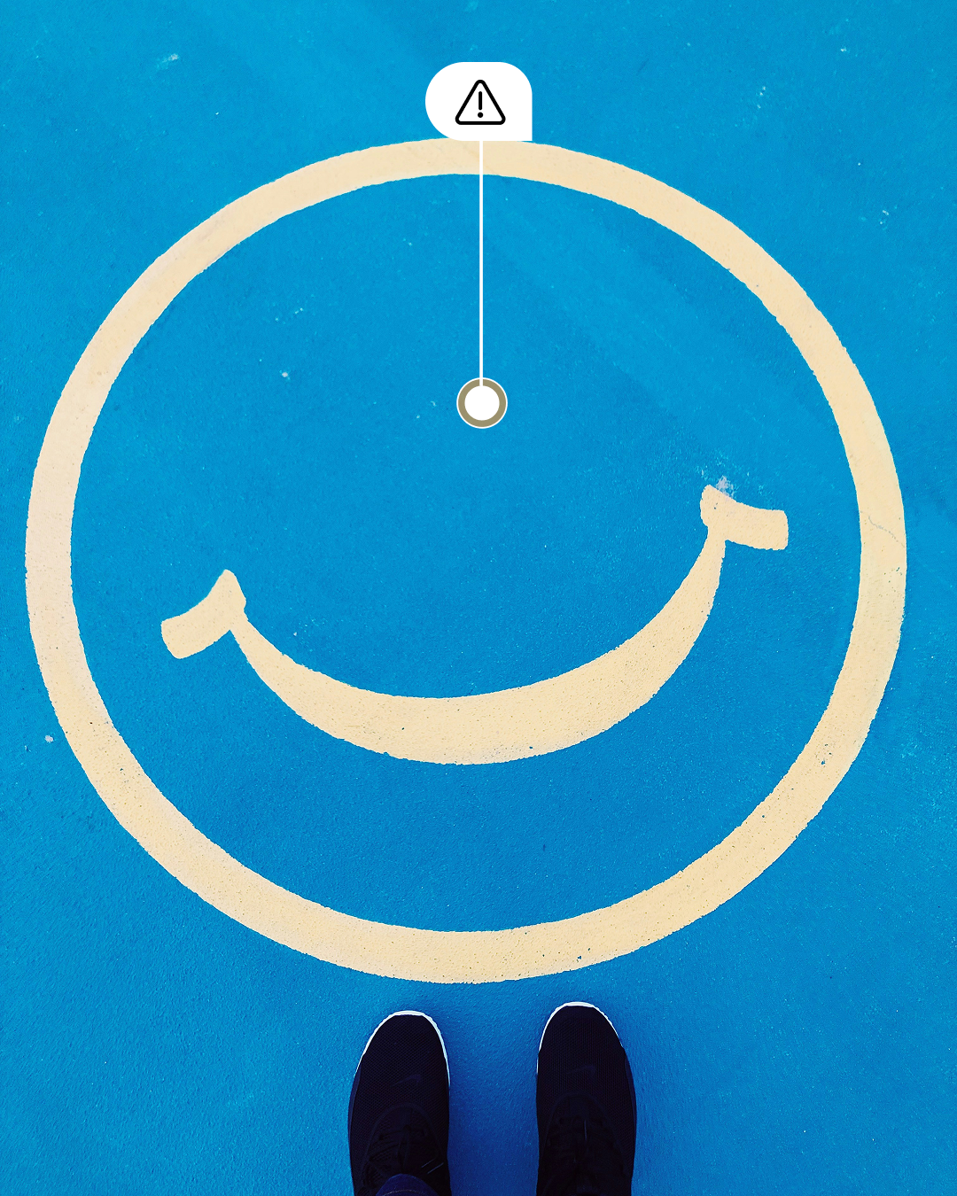 Blue square icon with a white circular smiley face symbol