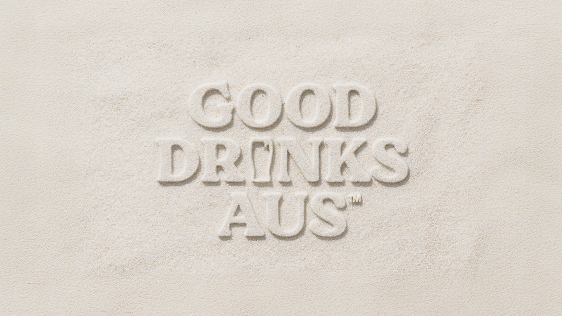 Good Drinks Aus wordmark pressed into a sandy textured surface