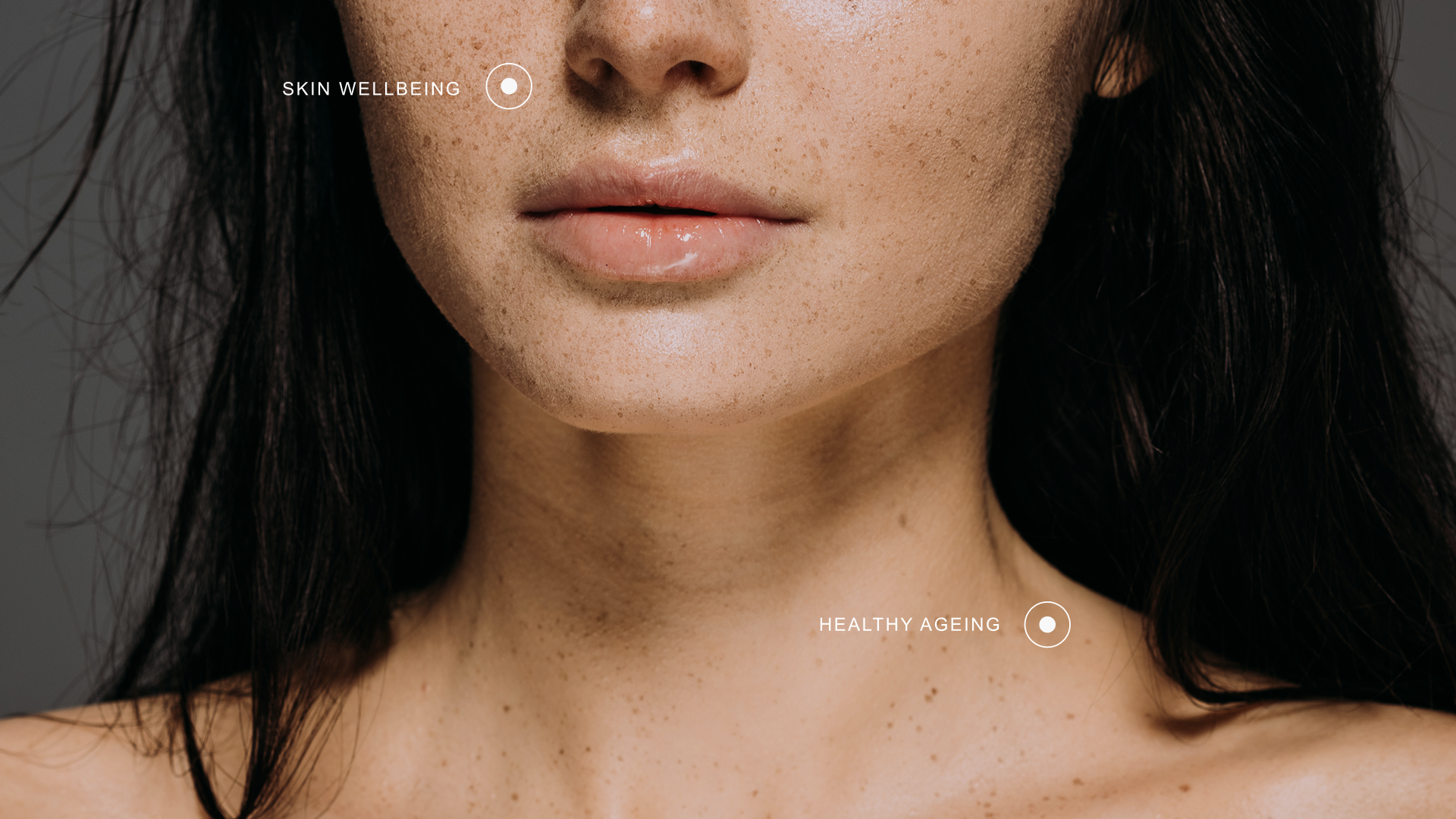Close-up natural-light portrait of a woman with dark hair looking slightly to the side — lifestyle wellness campaign photography