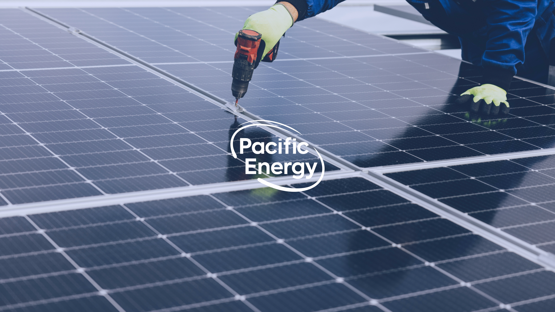 Aerial side view of a Pacific Energy solar panel array with Pacific Energy logo visible