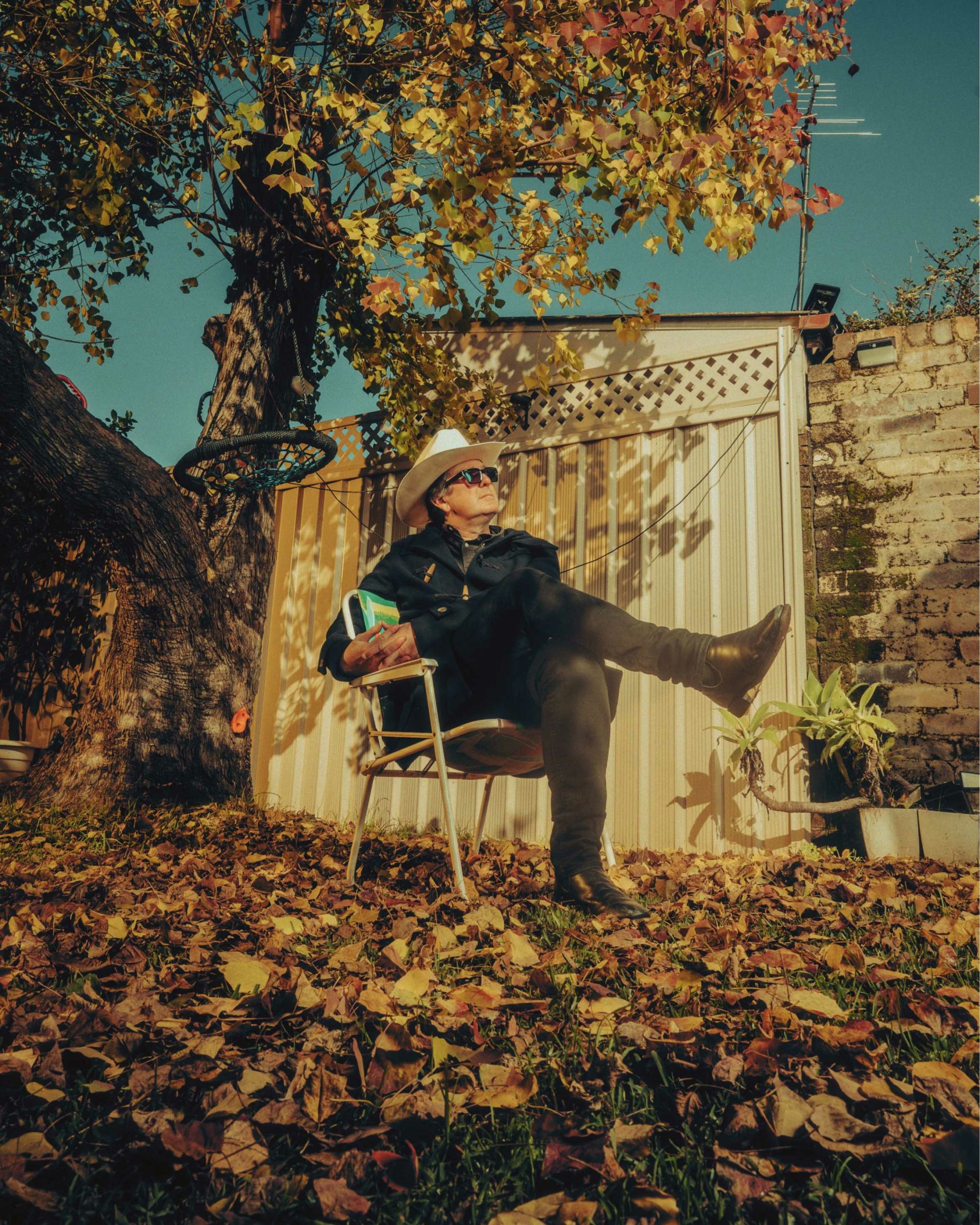 Dave McCormack in a moody autumn outdoor setting with golden fallen leaves