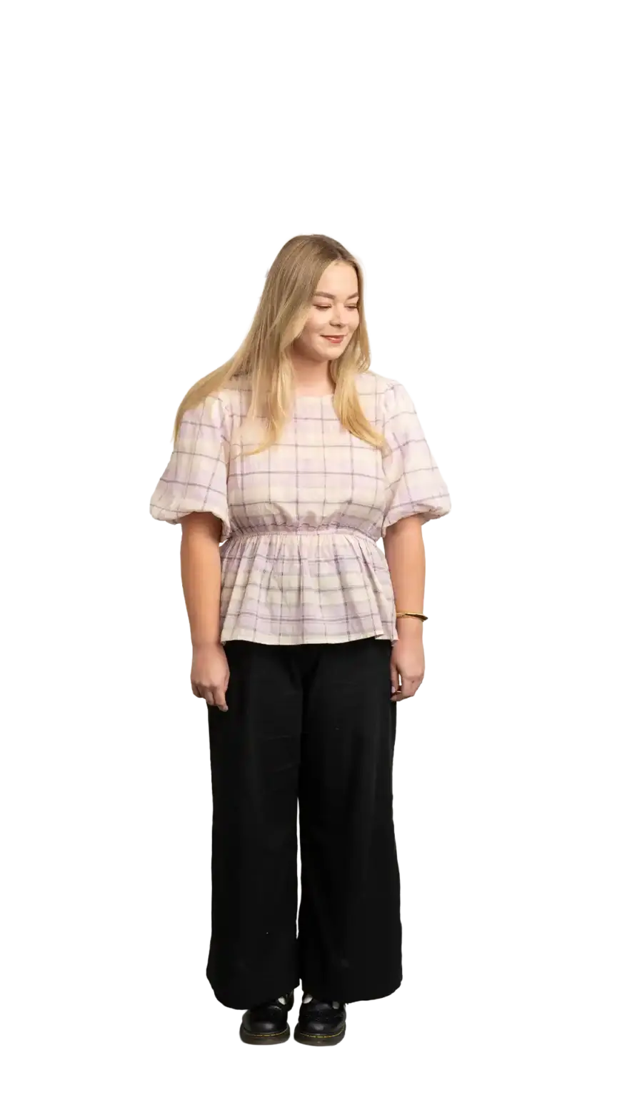 Indi Calvert, Creative Designer at The Start, full-body portrait — looking down and to the right