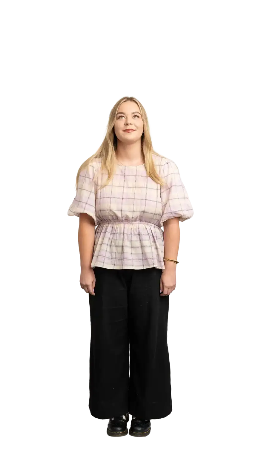Indi Calvert, Creative Designer at The Start, full-body portrait — looking straight up