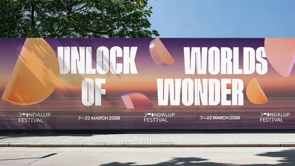 Large-format street hoarding for Joondalup Festival 2026 showing Unlock Worlds of Wonder headline with prismatic 3D hemispheres against a sunset gradient