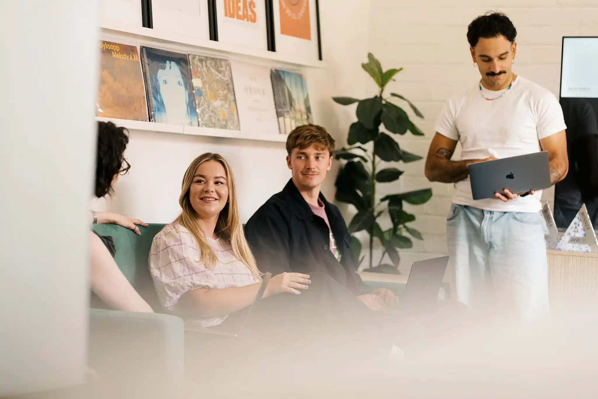 Three members of The Start team — two women and a man — smiling together in a bright studio or office space, January 2026