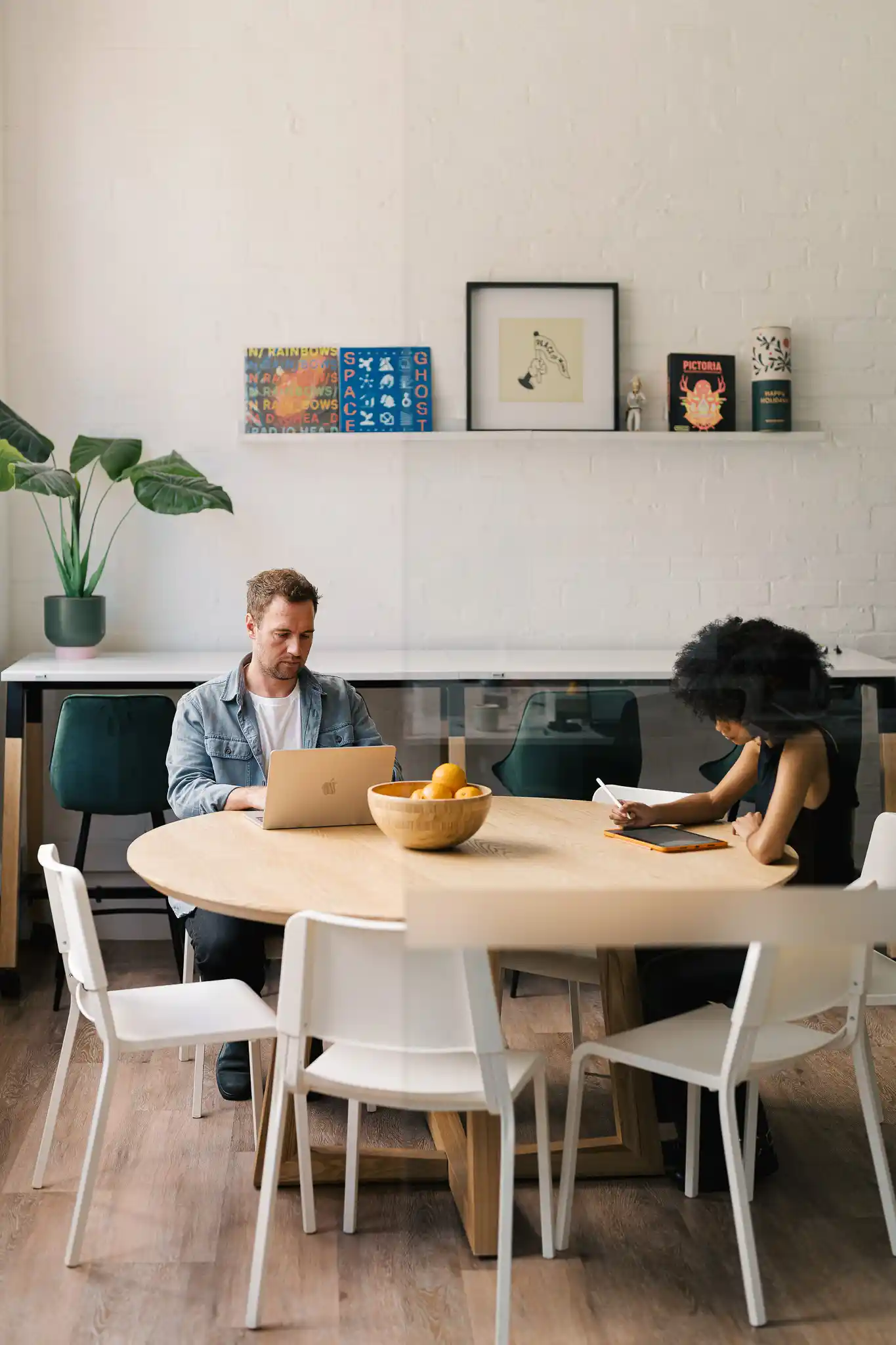 The Start office workspace — bright modern meeting area with tables, chairs, and a clean open-plan layout